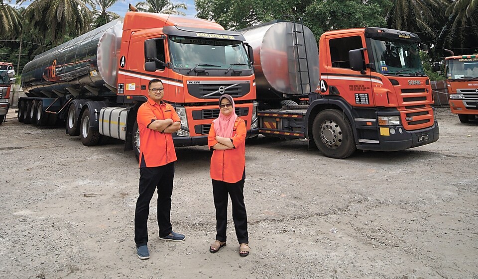 Men and women standing near truck