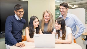 Who we are: Colleagues having a discussion in Shell office