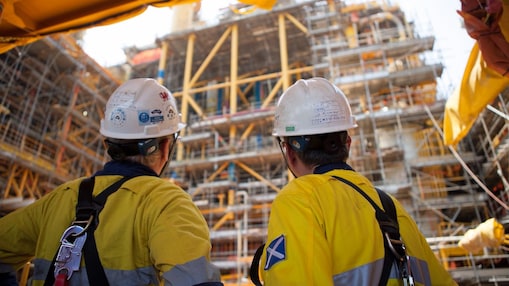 Two men looking at construction of a platform