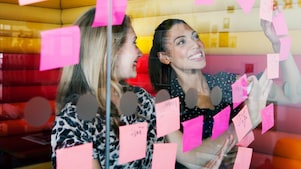 Female workers discussing work in dymanic work environment