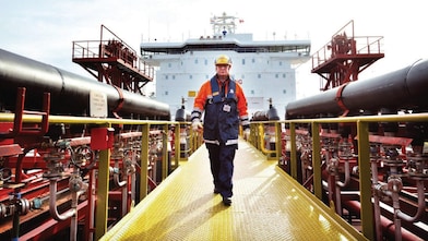 worker walking around a Shell vessel