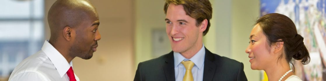 Three employees discussing work