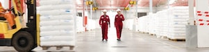 two employees walking in a factory