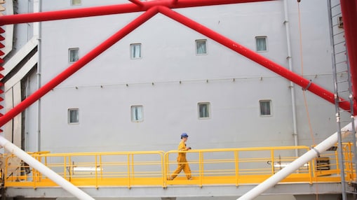 Engineer walking across a North sea offshore platform in Aberdeen