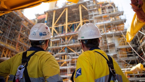 Two men looking at construction of a platform