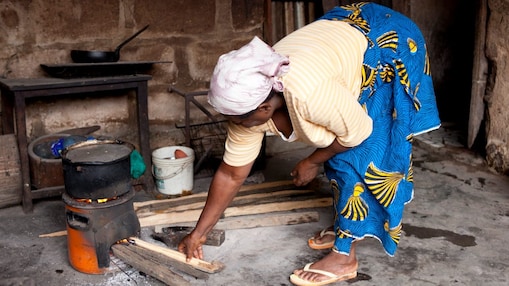 Lady cooking on a cookstove in Nigeria