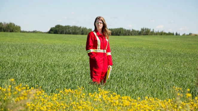 An employee stands in a field near a Quest C02 injection well northeast of Edmonton, Alberta in Canada