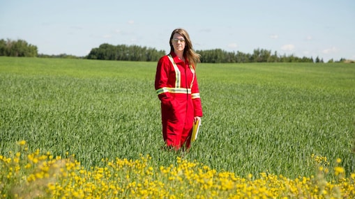 An employee stands in a field near a Quest C02 injection well northeast of Edmonton, Alberta in Canada