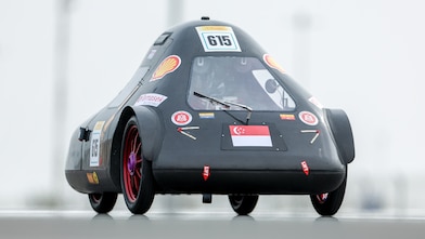SEM 1 	Temasek Polytechnic's TP EcoFlash vehicle races along the track during the Shell Eco-marathon competition, demonstrating student-led engineering and energy-efficiency innovation.