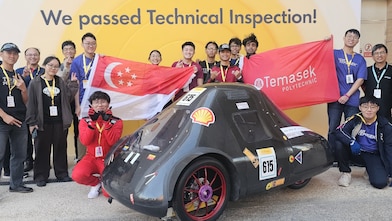 Temasek Polytechnic’s TP EcoFlash team poses with their vehicle after passing technical inspection at the Shell Eco-marathon.
