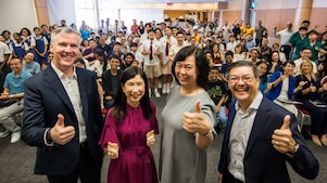 Secondary school students, educators from Nanyang Polytechnic and Science Centre, and Shell representatives gather for a group photo at the Shell NXplorers Carnival 2025 event, giving thumbs-up to the camera.