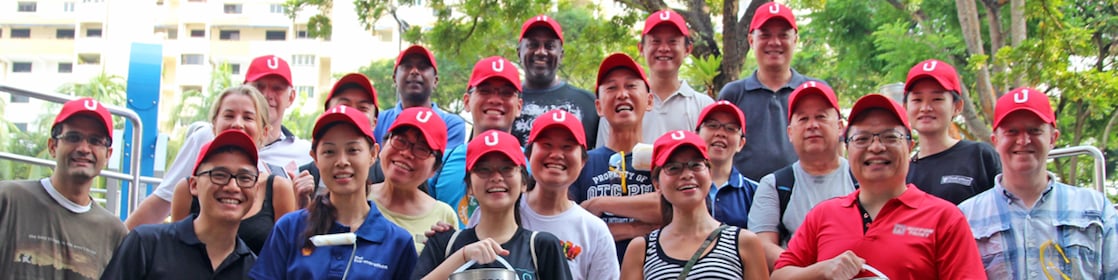 Volunteers painting a mural at the Let’s Paint activity