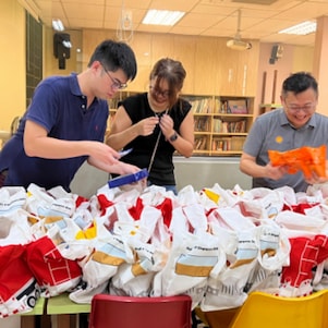 Shell Singapore volunteers pack goodie bags for children at Lakeside Student Care following a creative painting workshop and games.