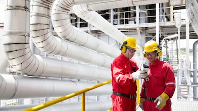 Two engineers having a discussion in the refinery plant.