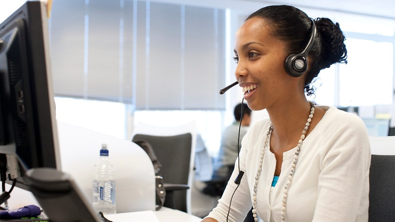 Woman in call centre facing her computer screen