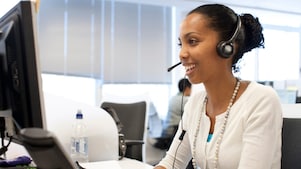 Woman in call centre facing her computer screen