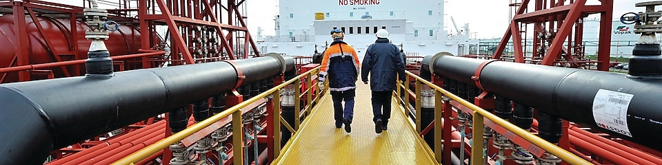 Shell employee walking along on a tanker 