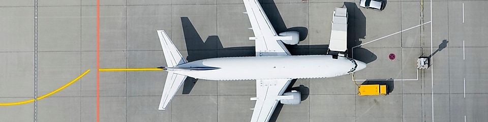 Aerial view of airplane and vans