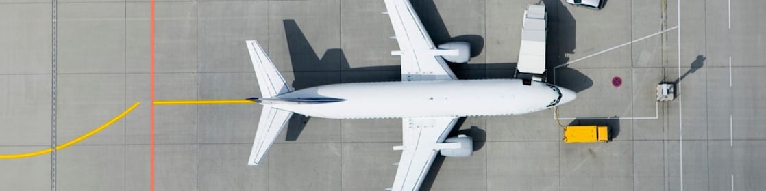 Aerial view of airplane and vans