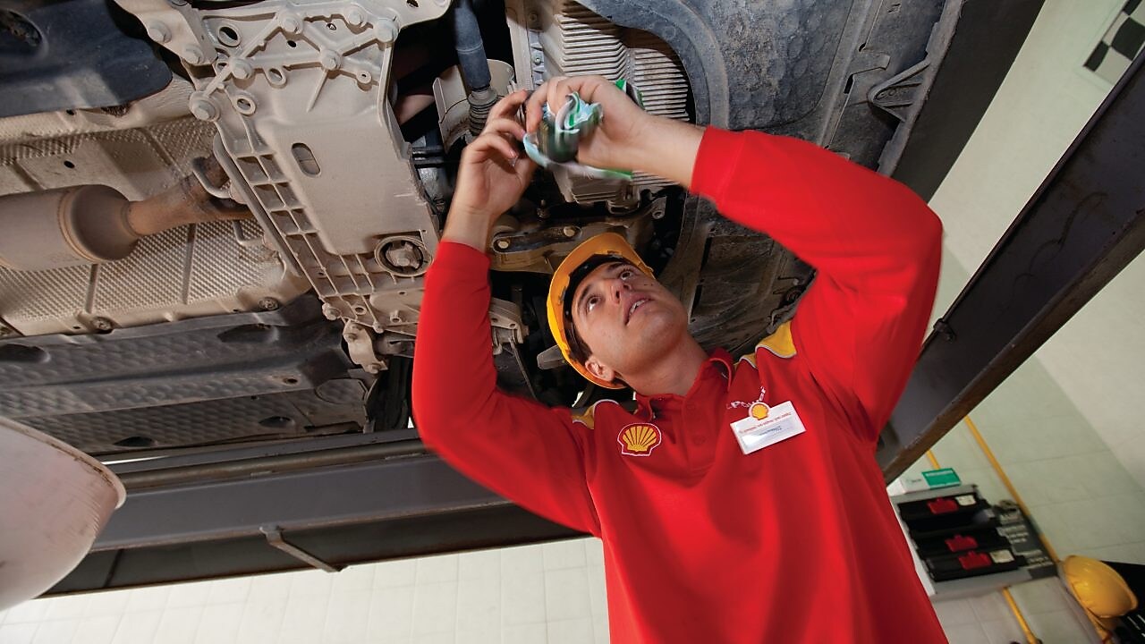 employee doing fitting of parts in car