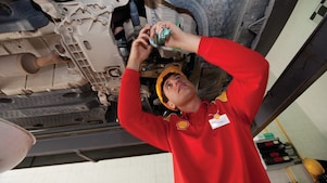 employee doing fitting of parts in car