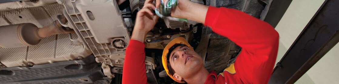 employee doing fitting of parts in car