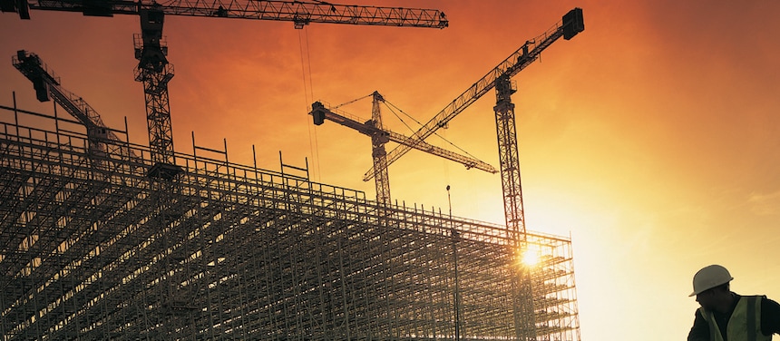 Cranes in construction site in sunset