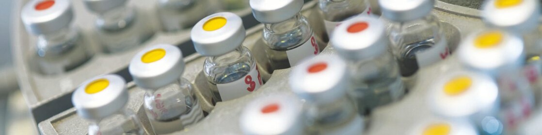 Five beakers in a row with a clear liquid in each one