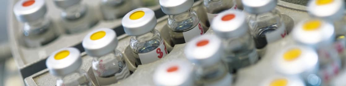 Five beakers in a row with a clear liquid in each one