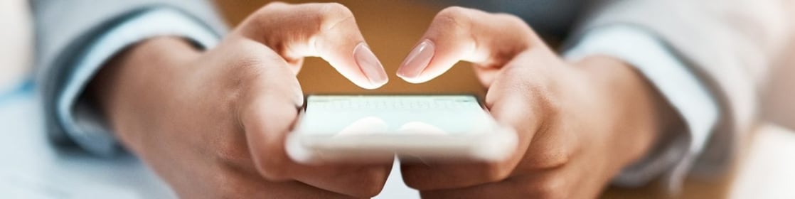Two hands shown using a mobile device to send an email