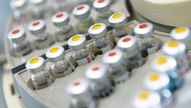 Five beakers in a row with a clear liquid in each one