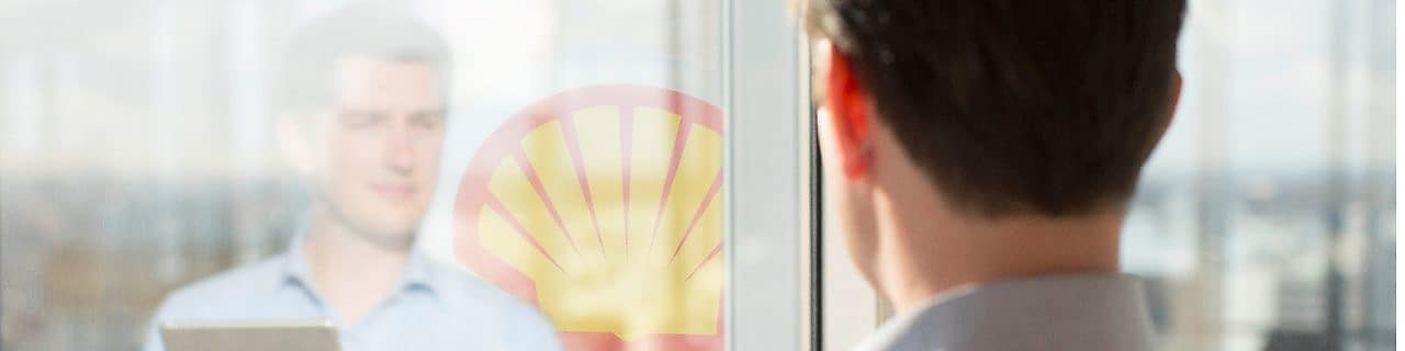 Man holding a Tab while looking at mirror