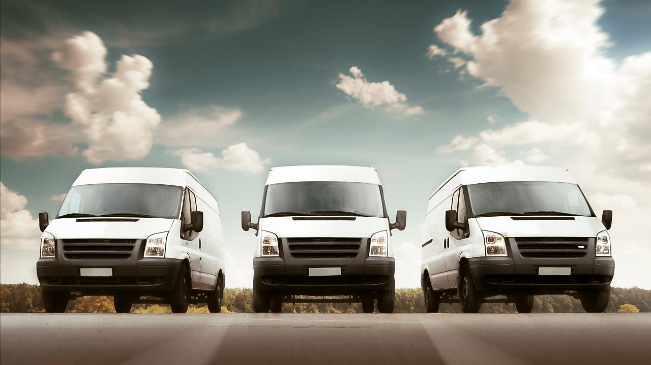 Three cars parked besides each other