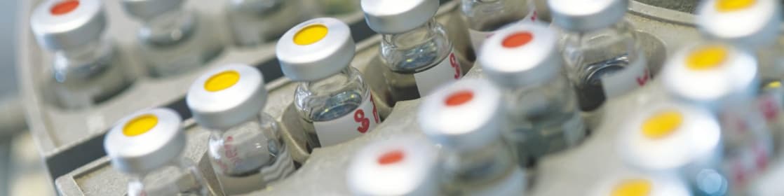Five beakers in a row with a clear liquid in each one