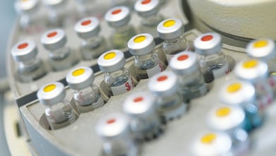 Five beakers in a row with a clear liquid in each one
