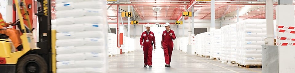 Two employees walking in a factory