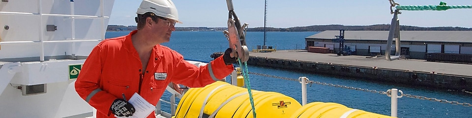 Employee inspectring equipment on a docked boat