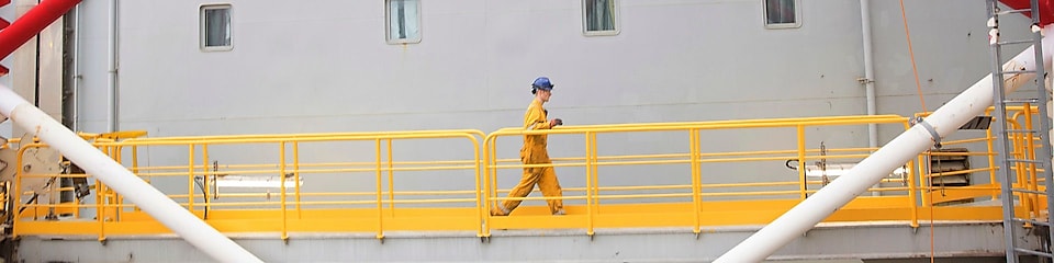 Engineer walking across a North sea offshore platform in Aberdeen