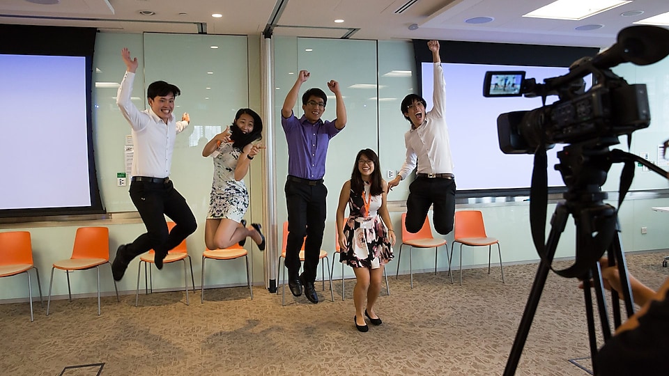 Five singapore students jumping in front of camera