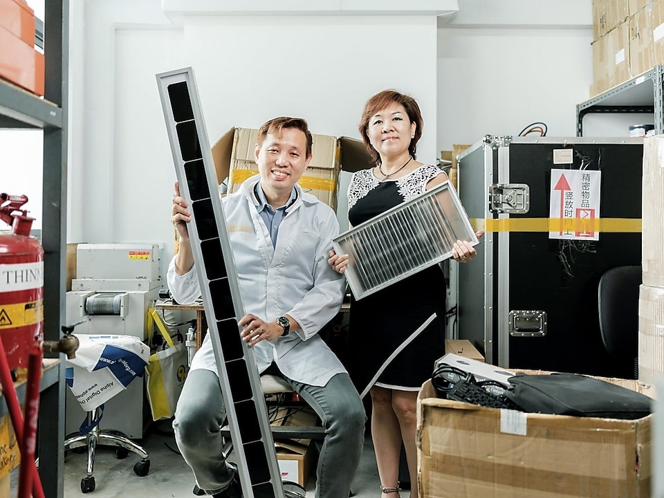 Husband and Wife duo Terence Ong and Julie Ong with their solar panel. 
