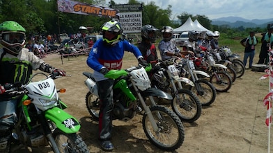 Motorcross motorcycles lining up at the start of a race
