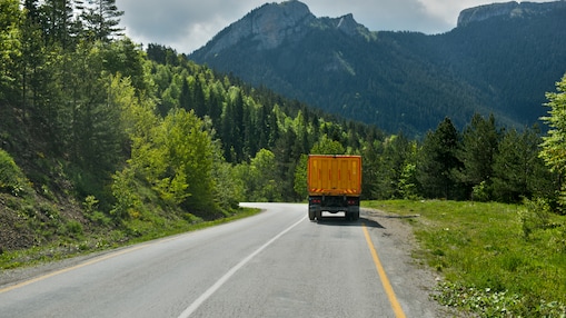 Truck driving towards the mountains.