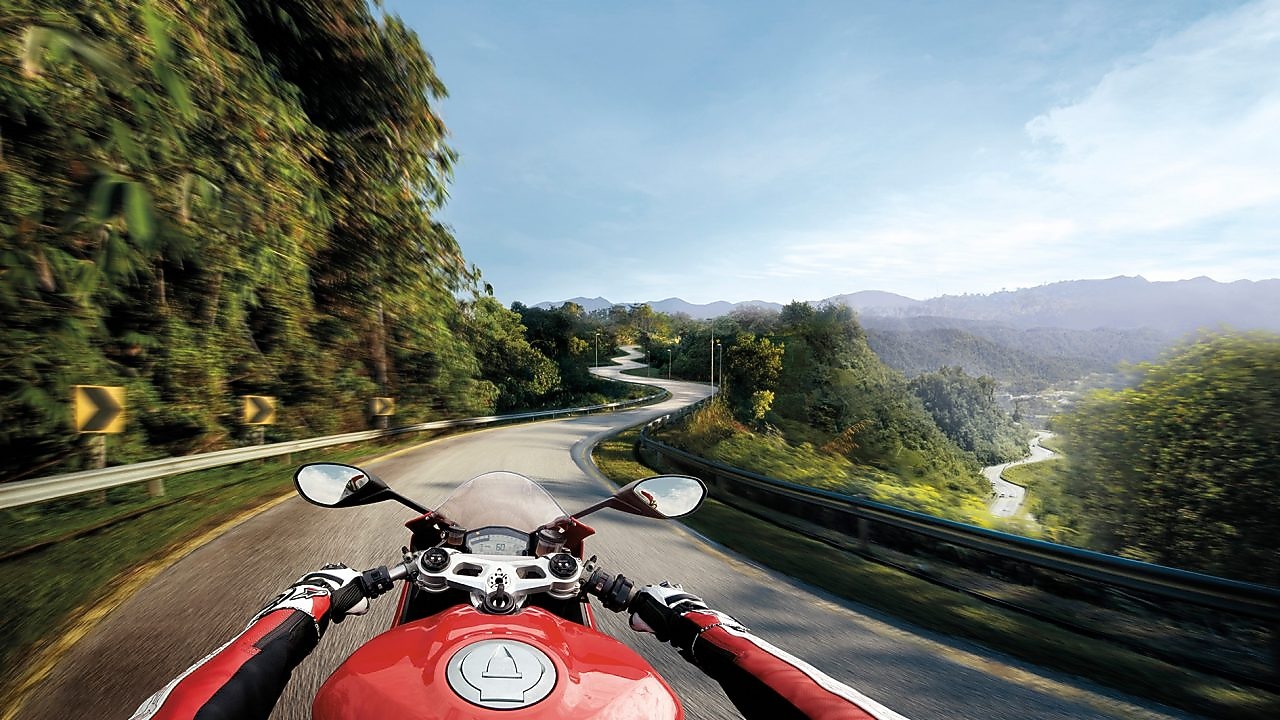 Man riding a bike which is using the Superior Engine Oil For Bikes