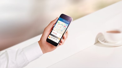 A close up of a person’s hand holding a smart phone