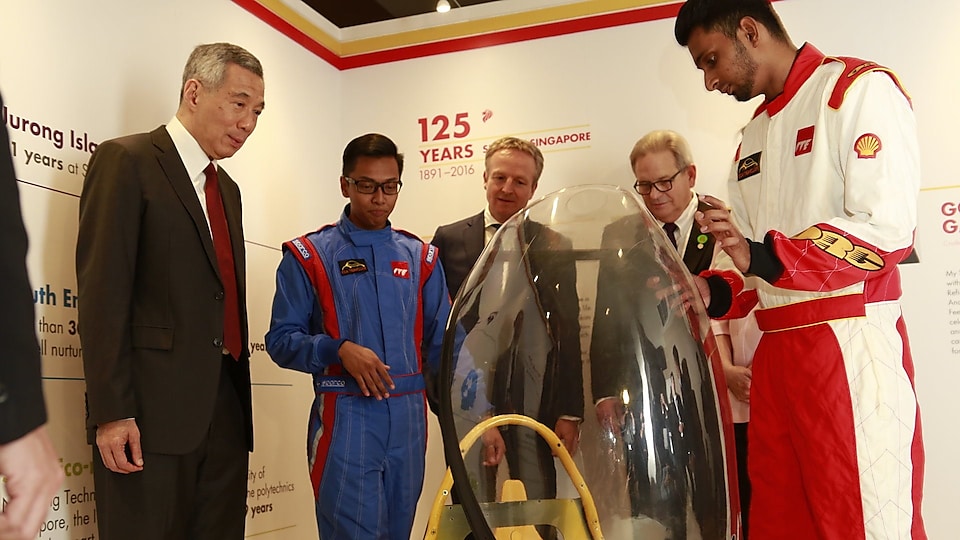 Shell Eco-marathon Asia student reps from ITE shares with PM Lee the making of EcoTraveller, a battery-electric-powered prototype, as Chad Holliday and Maarten Wetselaar from Shell look on