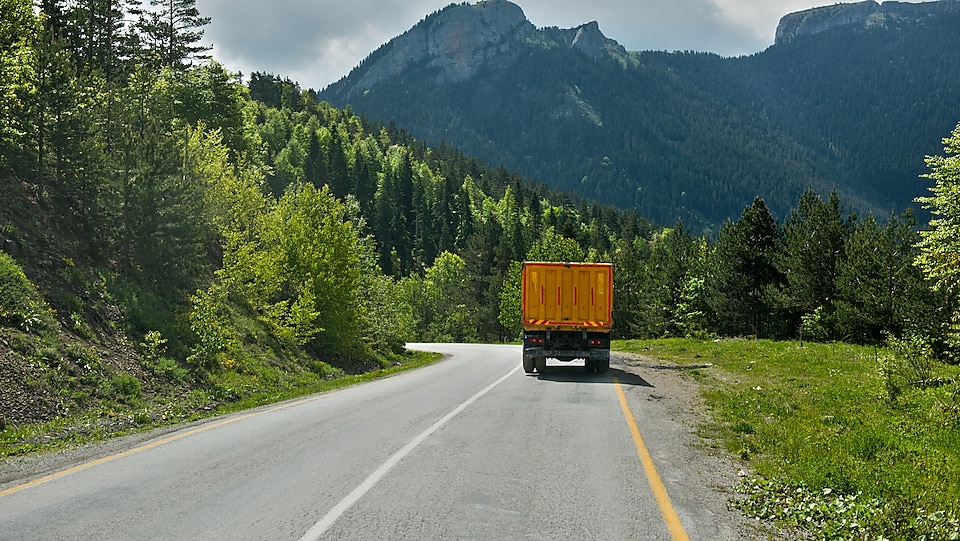 Truck driving towards the mountains.