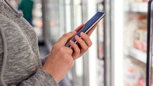 Customer holding their phone.