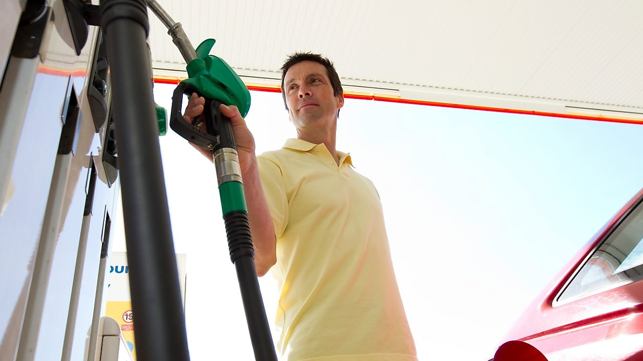 Man standing at the petrol pump