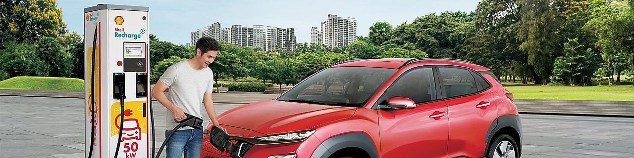 Man filling car at Shell recharge station