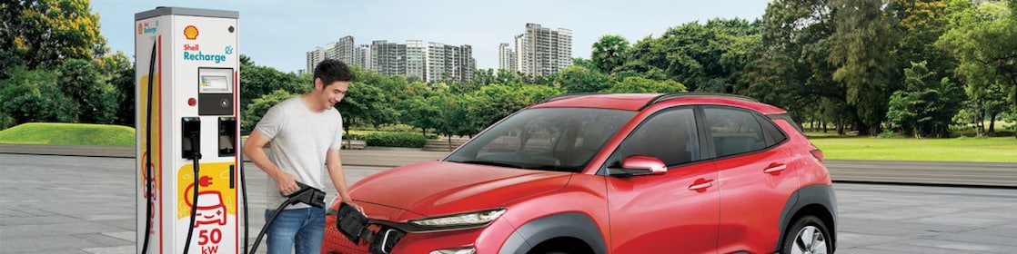 Man filling car at Shell recharge station